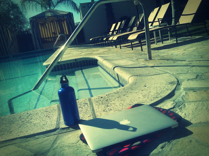 Laptop by the swimming pool